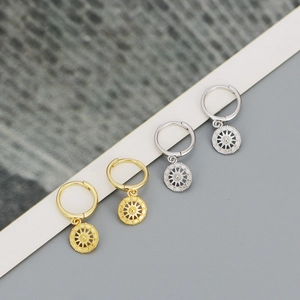Detail showing gold and silver S925 sterling silver star compass hoop earrings