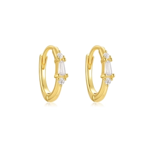 Detail of gold hoop earrings featuring emerald cut and round cubic zirconia stones