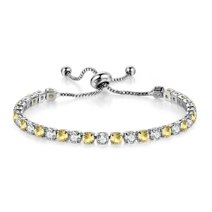 Detail of adjustable tennis bracelet with alternating yellow and white round-cut zircons