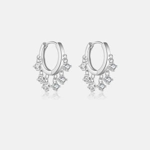 Macro detail of S925 sterling silver hoop earrings with sparkling zircon star pendants