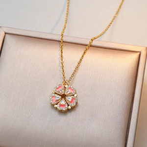 Pink heart clover necklace in gold finish with sparkling zircons on jewelry box