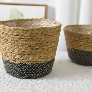 Close-up of handmade seagrass basket with black contrast and decorative zigzag stitching