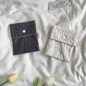 Detailed view of floral storage bags with textured fabric and snap button closure