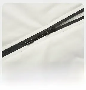 Detailed close-up of a premium black double zipper on a cream fleece-lined warm jacket