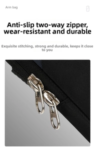 Detailed macro view of the durable double metal zippers on this black sport arm bag