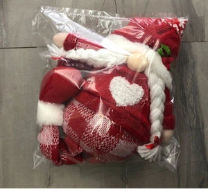 Unpacked Christmas faceless gnome plush in red knitted sweater inside clear polybag