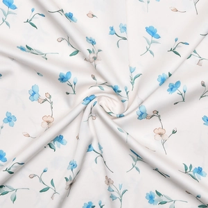 Close-up of elegant satin fabric with blue and pink floral print for evening dress