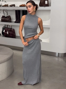 Elegant grey ribbed knit two-piece set with sleeveless turtleneck top and maxi skirt
