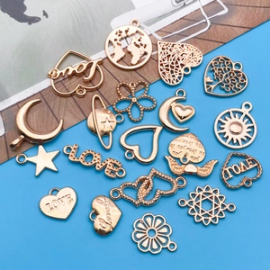 Macro shot of KC gold hollow heart, star, and love letter charms for DIY jewelry making