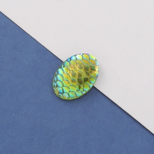 Close-up of 13x18mm oval fish scale resin cabochon with yellow-green gradient AB finish