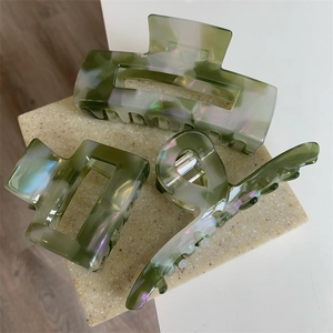 Three-piece set of green iridescent acetate hair claws in various geometric shapes