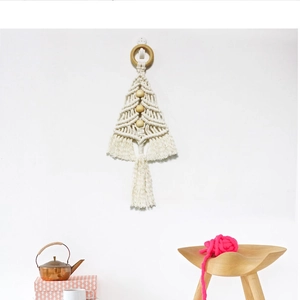 Detail of handmade macramé Christmas tree wall hanging with cotton rope and wooden beads