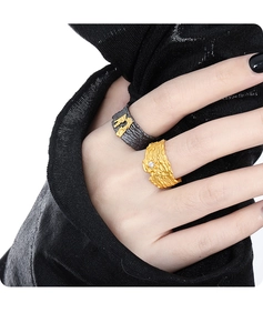 Detailed view of textured S925 silver rings with gold finish and black volcanic stone texture