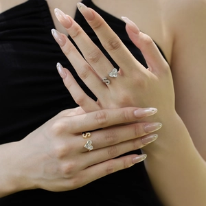 Close-up of S925 silver adjustable rings with heart-shaped zircon and S-letter details