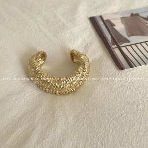 Textured gold braided open cuff bracelet with vintage lava-inspired irregular stripes
