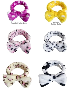 Close-up of coral fleece headbands in leopard print and polka dot assorted patterns