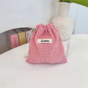 Detail of pink cotton linen drawstring pouch with woven texture and Sozakka woven label