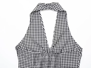 Detail of gingham halter dress featuring smocked back panel and deep V-neckline texture