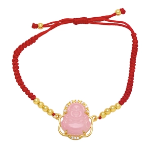 Detail of red braided rope bracelet with pink Buddha pendant and sparkling zircon accents