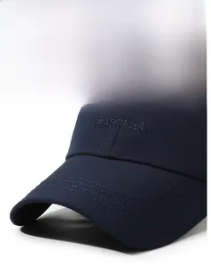 Detail of navy cotton baseball cap showing 3D Near&Dear embroidery and stitched brim