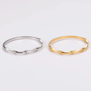 Bamboo-style stainless steel bangle set with rhinestones in gold and silver finish