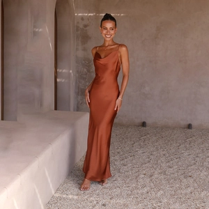Detail of the rust red satin maxi dress featuring a draped neck and smooth silk texture