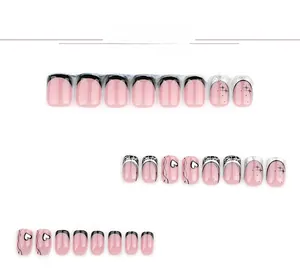 Detail view of 24pcs pink French press-on nails with black hearts and silver star motifs