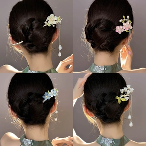 Elegant Chinese hair pins with floral ornaments and tassels shown on a bun hairstyle