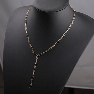 Detail of gold paperclip chain Y-necklace displayed on a black matte bust jewelry display