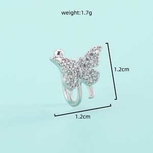 Detailed macro view of silver butterfly ear clip with sparkling cubic zirconia stones