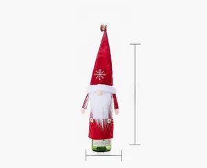 Detailed size view of red Christmas gnome wine bottle cover with white snowflake embroidery