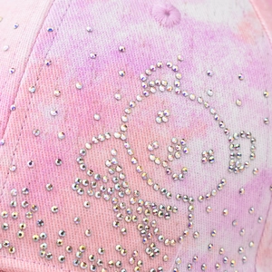 Pink tie-dye baseball cap with colorful crystal bear motif and sparkling rhinestone accents