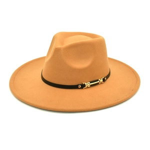 Detail of camel wool fedora hat featuring a black leather band and gold metal buckle