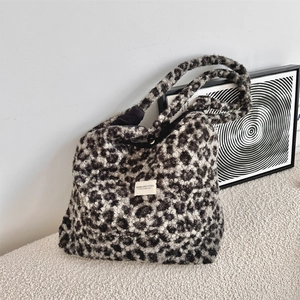 Close-up of leopard print faux shearling tote bag showing plush texture and brand label
