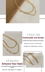 Detail of 18k gold double-layer necklace with snake chain and paperclip link