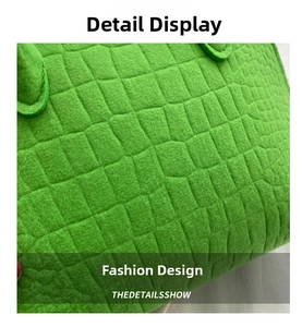 Detailed macro view of lime green felt material with crocodile pattern on shell bag