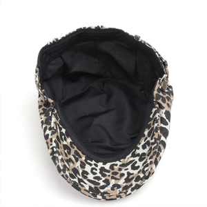 Detail of leopard print beret with black lining and vintage side metal button accent