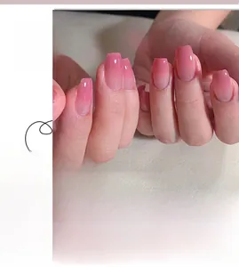 Detail of pink gradient press on nails in short ballet style with glossy finish