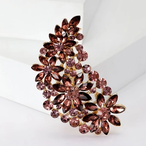 Detail of purple crystal brooch with gold metal base in crescent flower design
