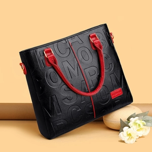 Black embossed leather handbag for women featuring stylish red handles and spacious design