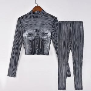 Detail of sheer mesh crop top with abstract eye print and matching patterned leggings
