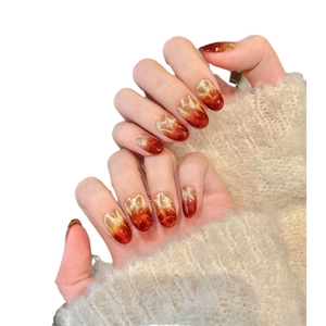 Handmade burgundy cat-eye press-on nails with shimmering gold gradient and water ripple finish