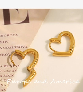 Macro shot of gold-plated heart-shaped hoop earrings with elegant镂空 design details