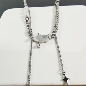 Detail of silver cloud necklace with star charm, white beads and asymmetric chain