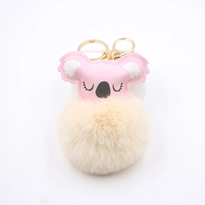 Close-up of fluffy koala keychain with pink leather head and gold lobster clasp detail