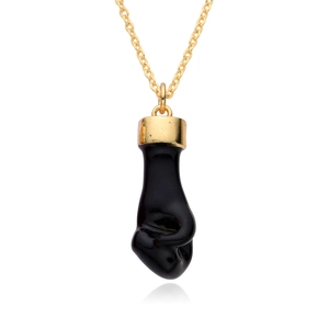 Detailed view of a black Mano Figa charm with gold metal cap on a delicate golden chain