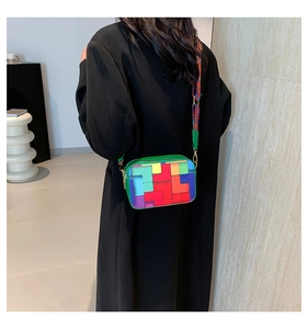 Detail of colorful geometric patchwork crossbody bag with vibrant woven shoulder strap