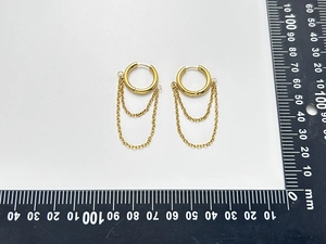 Detailed macro view showing the double layer tassel length on 18K gold plated hoop earrings