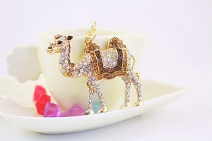 Macro shot of gold camel keychain with sparkling brown and clear rhinestones detail