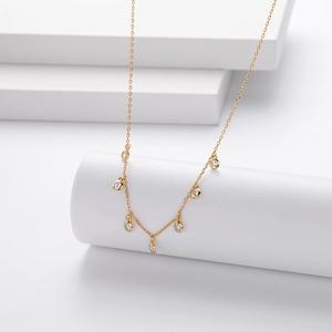 Minimalist S925 silver 18K gold necklace with seven round zircon charms on a white stand